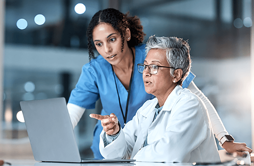 Researchers discussing results over a laptop